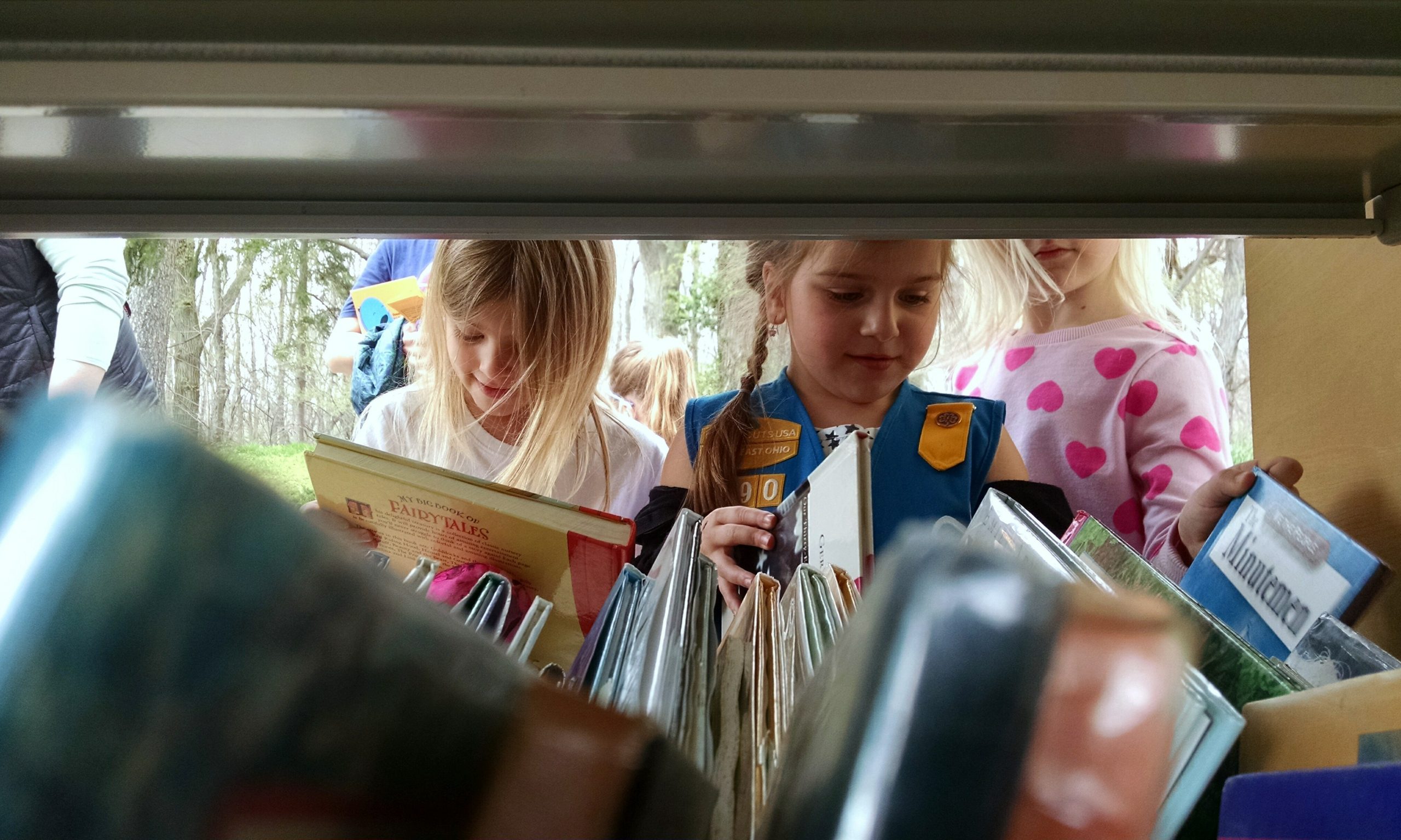 Children search the Pop-Up Library’s shelves during an Earth Day program at Wildwood Cultural Center.